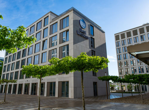 Best Western Hotel Wiesbaden Modern Best Western hotel building during the day, with trees in the foreground.